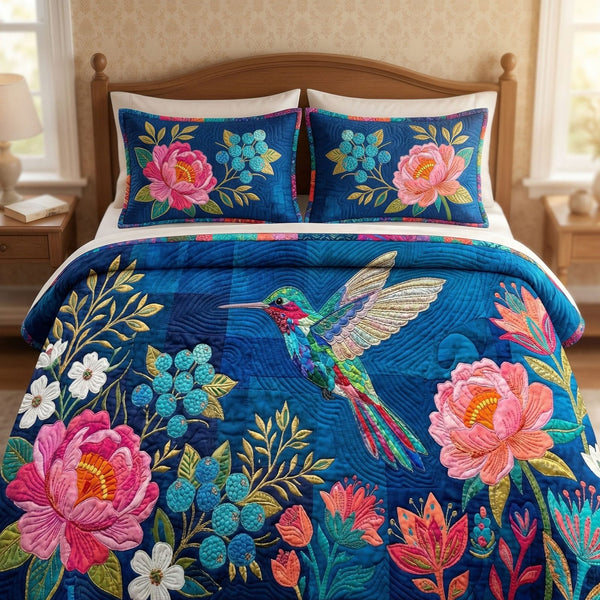 Royal Blue Bloom quilted 3-piece bedding set on a made bed with two matching pillow shams