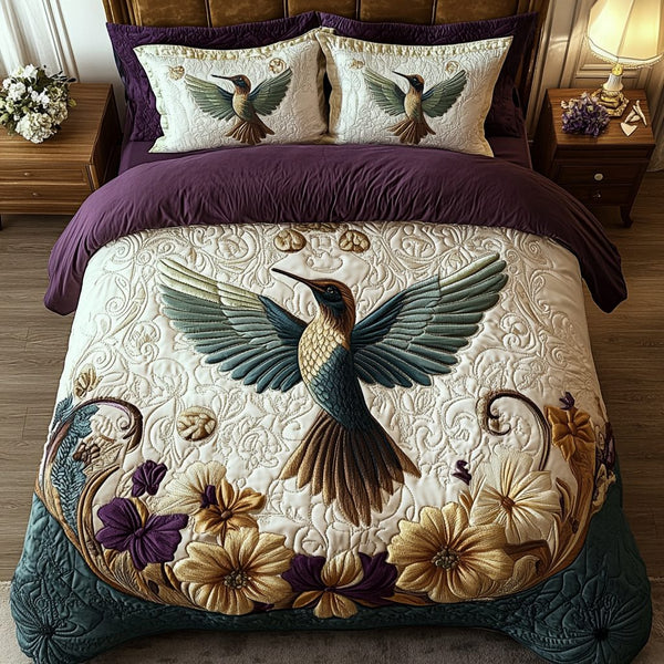Royal Hummingbird quilted 3-piece bedding set on a made bed with two matching pillow shams