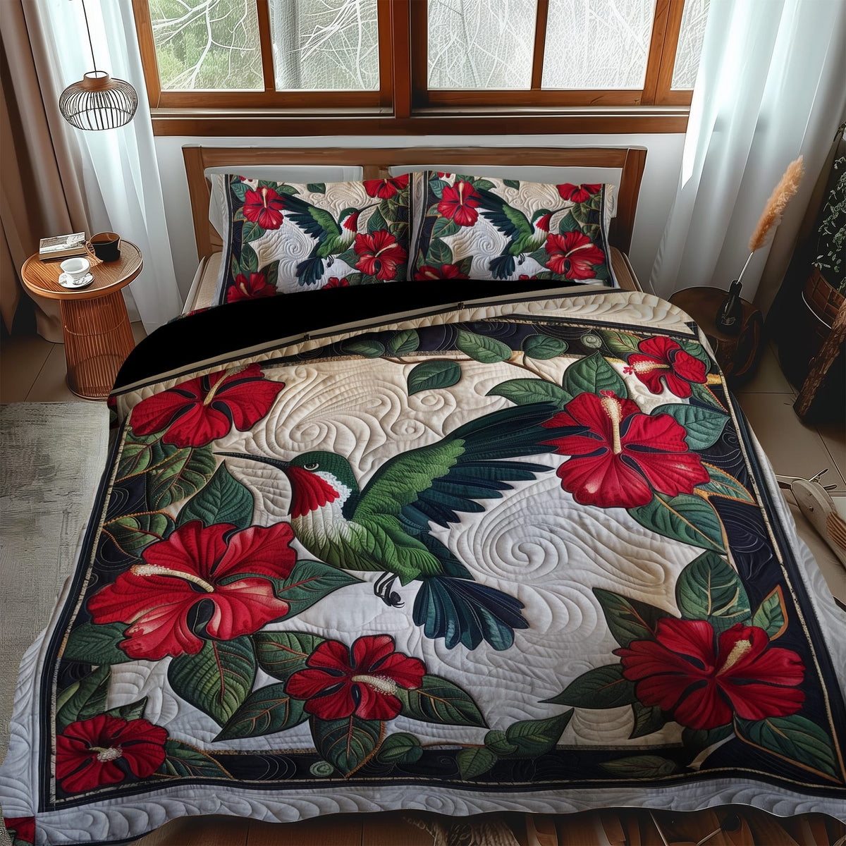 Ruby Hummingbird quilted 3-piece bedding set on a made bed with two matching pillow shams