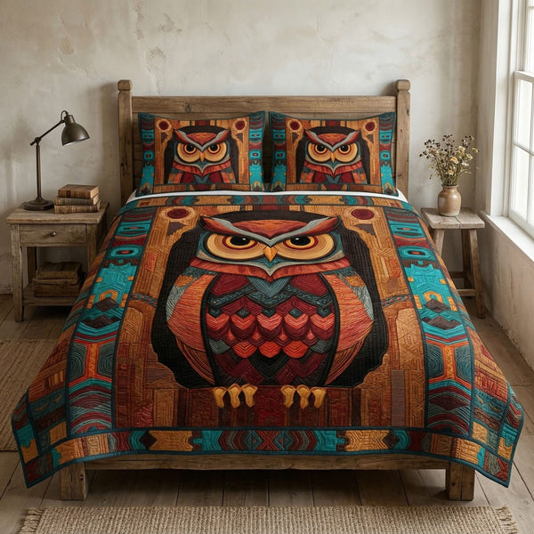 Sacred Owl quilted 3-piece bedding set on a made bed in a softly lit bedroom
