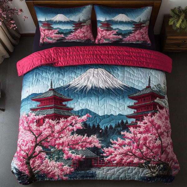 Sakura Whisper quilted 3-piece bedding set on a made bed with two matching pillow shams