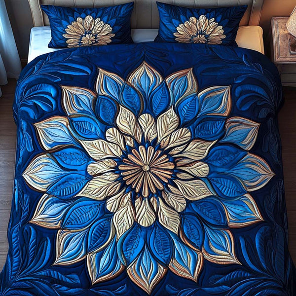 Sapphire Glow quilted 3-piece bedding set on a made bed with two matching pillow shams