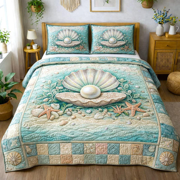 Sea Shells quilted 3-piece bedding set on a made bed in a light coastal bedroom