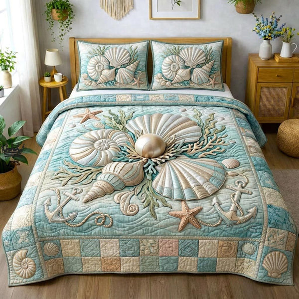 Sea Shells quilted 3-piece bedding set on a made bed in a light coastal bedroom