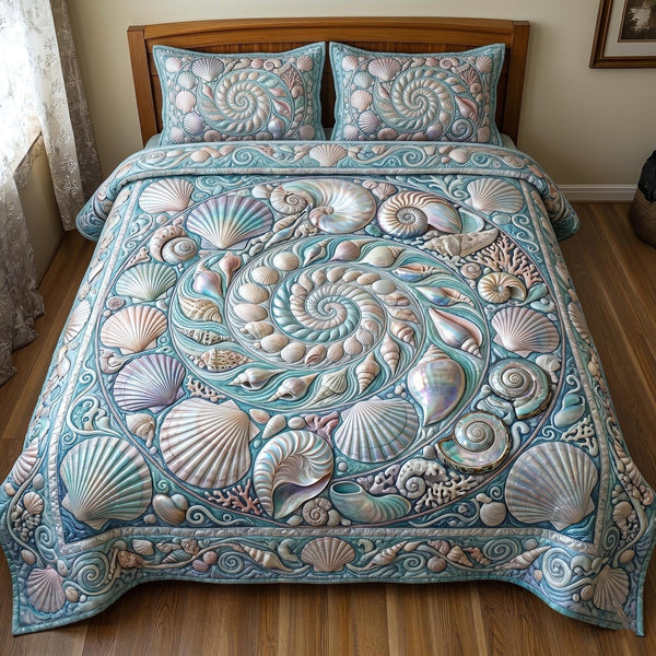 Sea Shells quilted 3-piece bedding set on a made bed in a light coastal bedroom
