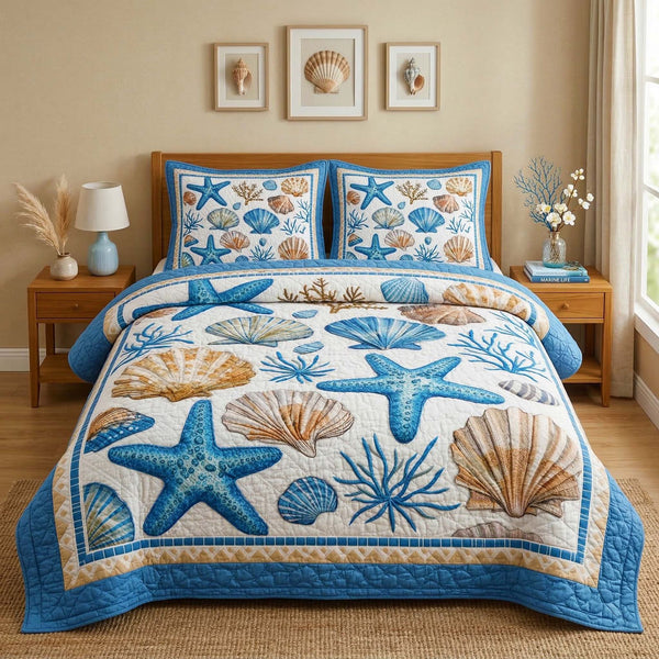 Seashell Garden quilted 3-piece bedding set on a made bed in a light coastal bedroom