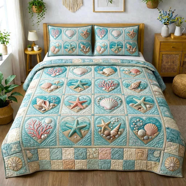 Seaside Shells quilted 3-piece bedding set on a made bed in a light coastal bedroom