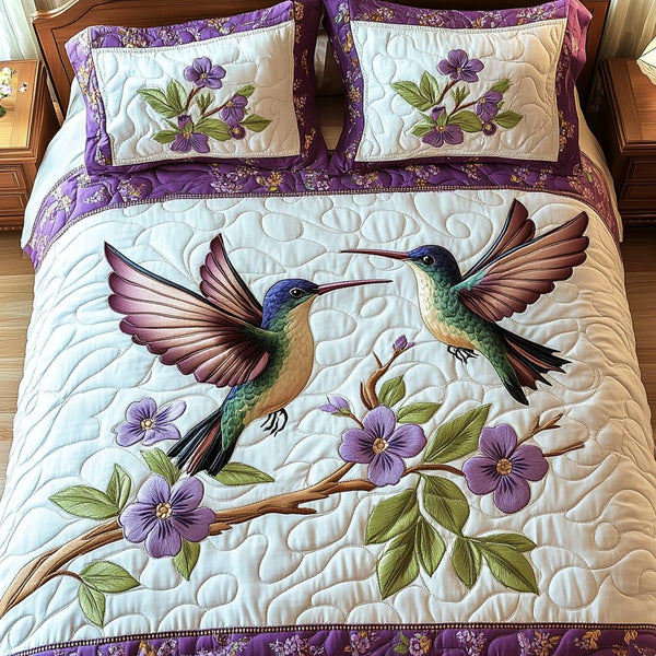 Serene Hummingbird quilted 3-piece bedding set on a made bed with two matching pillow shams