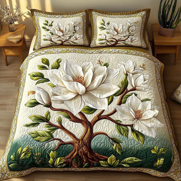 Serene Magnolia Bloom quilted 3-piece bedding set on a made bed with two matching pillow shams