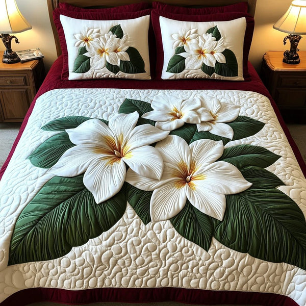 Serene Plumeria quilted 3-piece bedding set on a made bed with two matching pillow shams