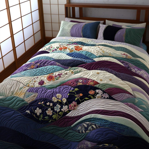 Serene Waters quilted 3-piece bedding set on a made bed with two matching pillow shams