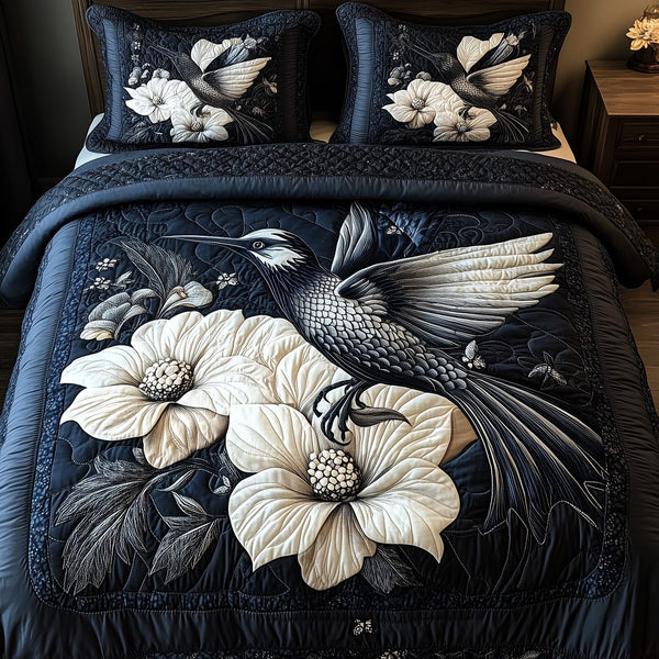 Shadowlight Hummingbird quilted 3-piece bedding set on a made bed with two matching pillow shams