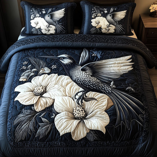 Shadowlight Hummingbird quilted 3-piece bedding set on a made bed with two matching pillow shams
