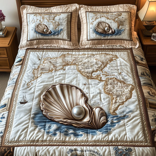 Shell quilted 3-piece bedding set on a made bed in a light coastal bedroom