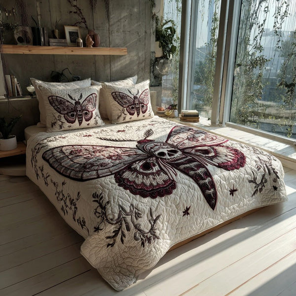 Skull Moth quilted 3-piece bedding set on a made bed against a dark styled interior