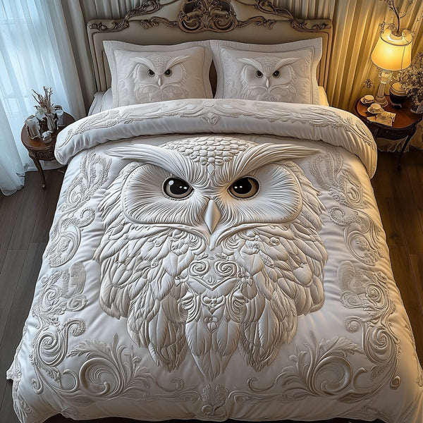 Snowy Owl quilted 3-piece bedding set on a made bed with two matching pillow shams
