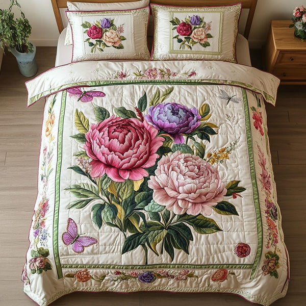 Soft Blossom quilted 3-piece bedding set on a made bed with two matching pillow shams