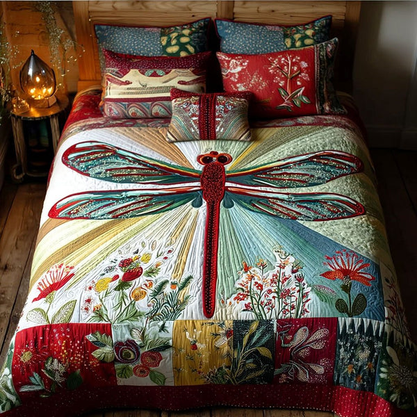 Solstice Dragonfly quilted 3-piece bedding set on a made bed with two matching pillow shams