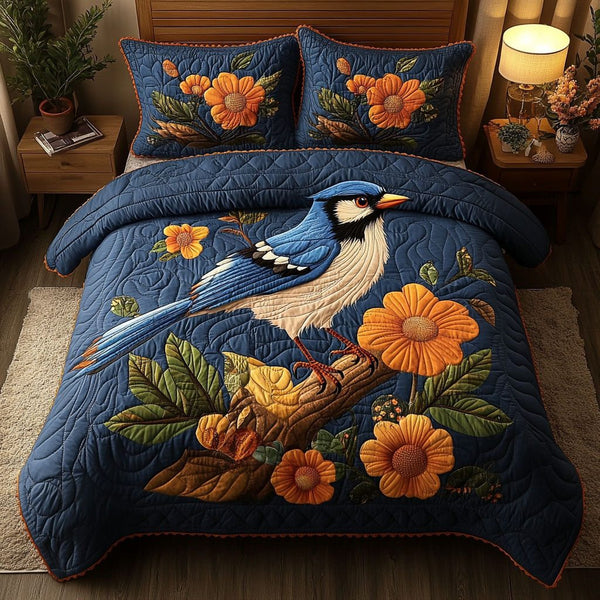 Songbird Serenity quilted 3-piece bedding set on a made bed with two matching pillow shams