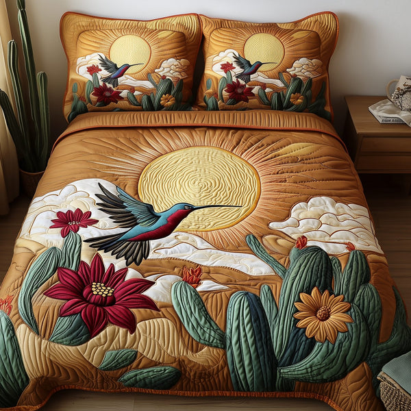 Southwest Spiritual Hummingbird quilted 3-piece bedding set on a made bed with two matching pillow shams