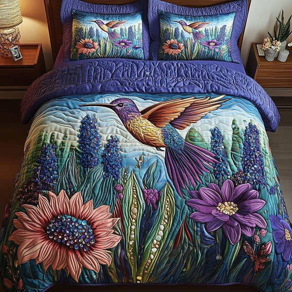 Sparkling Hummingbird quilted 3-piece bedding set on a made bed with two matching pillow shams