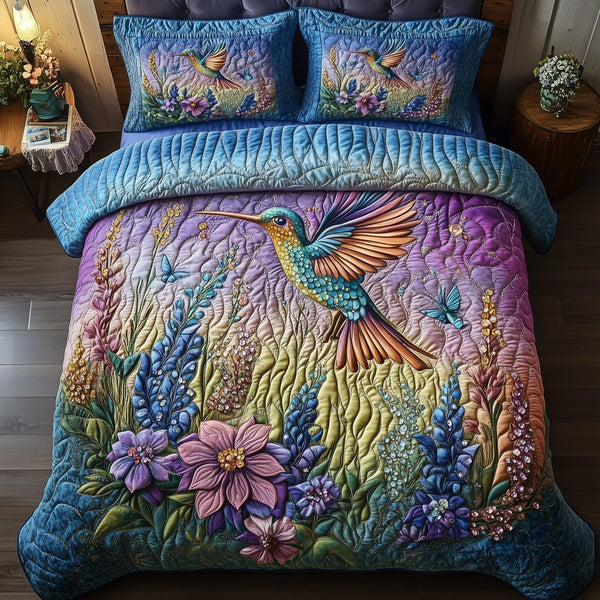 Sparkling Hummingbird quilted 3-piece bedding set on a made bed with two matching pillow shams