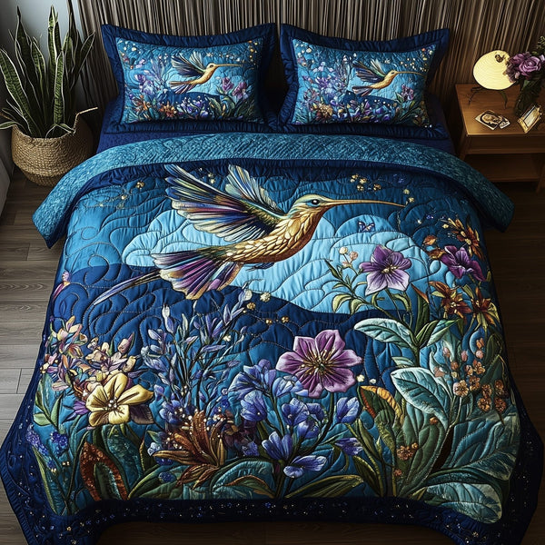 Sparkling Hummingbird quilted 3-piece bedding set on a made bed with two matching pillow shams