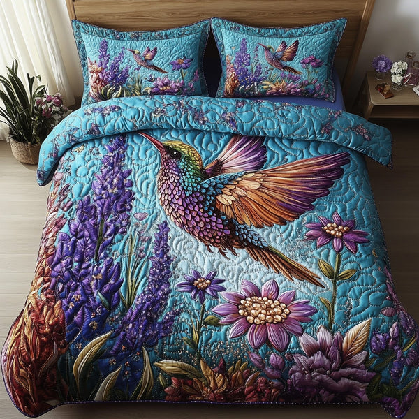 Sparkling Hummingbird quilted 3-piece bedding set on a made bed with two matching pillow shams