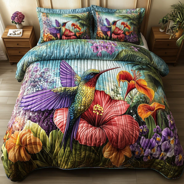 Sparkling Hummingbird quilted 3-piece bedding set on a made bed with two matching pillow shams