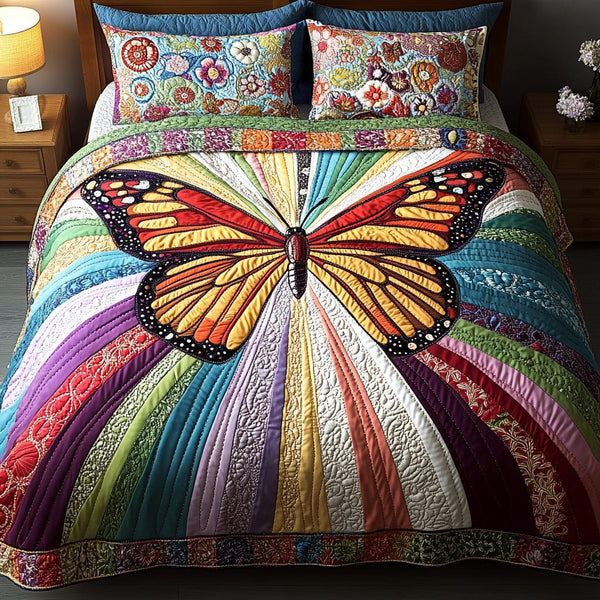 Spectrum Glow quilted 3-piece bedding set on a made bed with two matching pillow shams