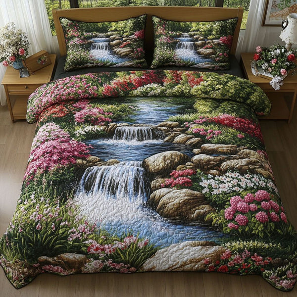 Spring Garden Stream quilted 3-piece bedding set on a made bed with two matching pillow shams