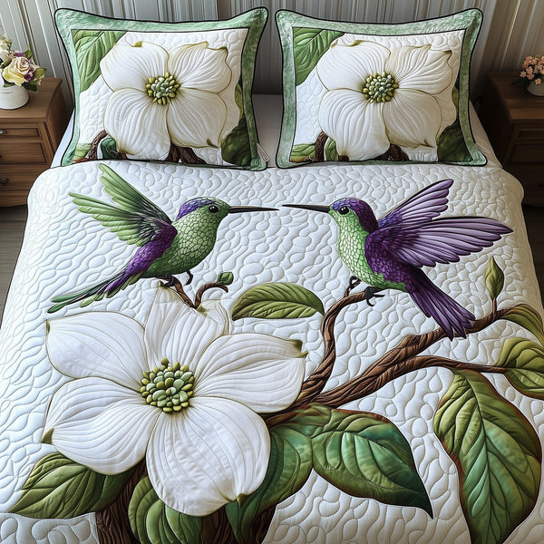 Spring Hummingbird quilted 3-piece bedding set on a made bed with two matching pillow shams