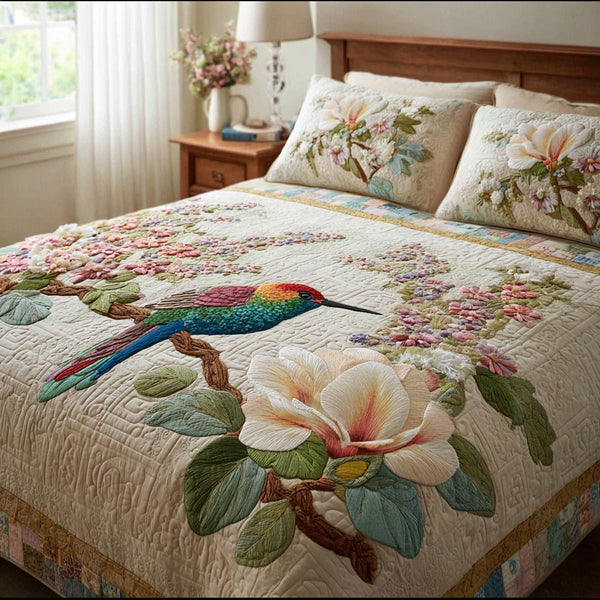 Spring Wings quilted 3-piece bedding set on a made bed with two matching pillow shams