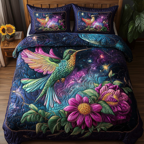 Stellar Hummingbird quilted 3-piece bedding set on a made bed with two matching pillow shams