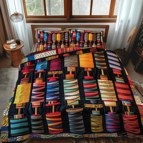 Stitcher Dream quilted 3-piece bedding set on a made bed with two matching pillow shams