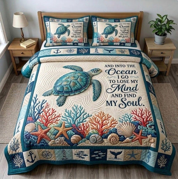 Summer Escape quilted 3-piece bedding set on a made bed with two matching pillow shams