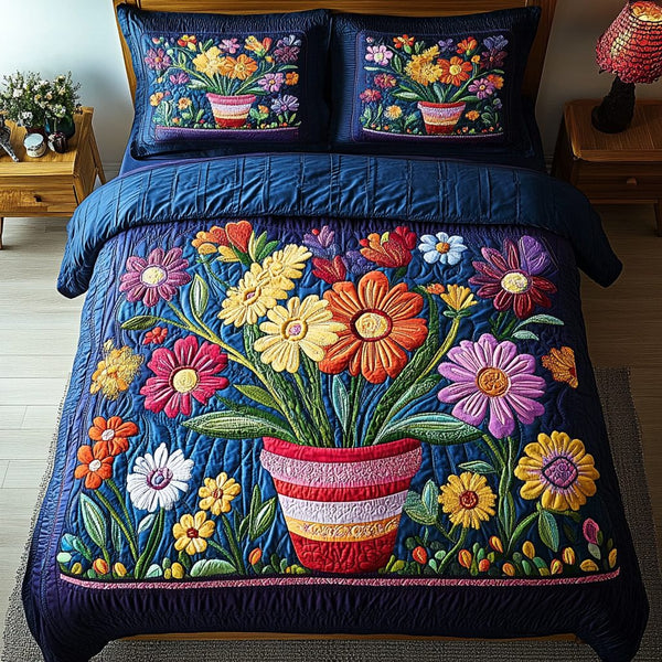 Summer Petals quilted 3-piece bedding set on a made bed with two matching pillow shams