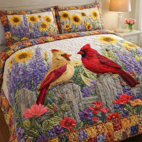 Sunlit Cardinal Meadow quilted 3-piece bedding set on a made bed with two matching pillow shams