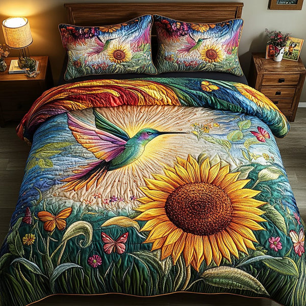 Sunlit Harmony Hummingbird quilted 3-piece bedding set on a made bed with two matching pillow shams