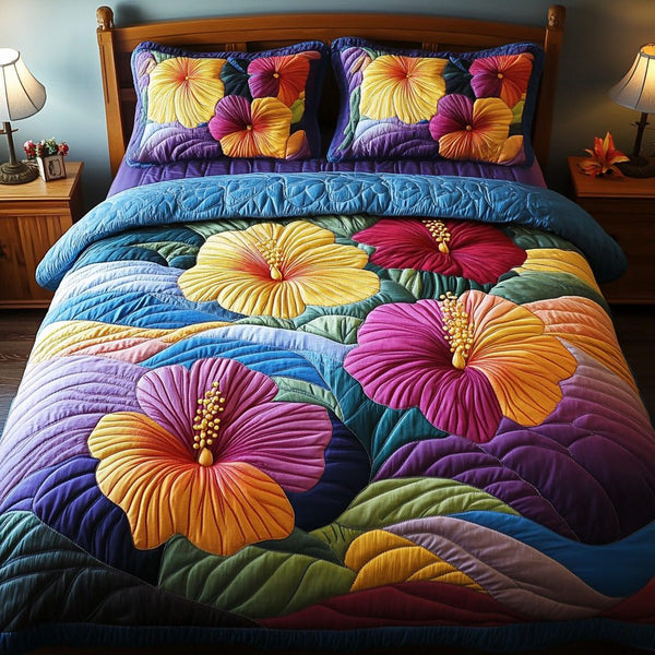 Sunset Bloom quilted 3-piece bedding set on a made bed with two matching pillow shams