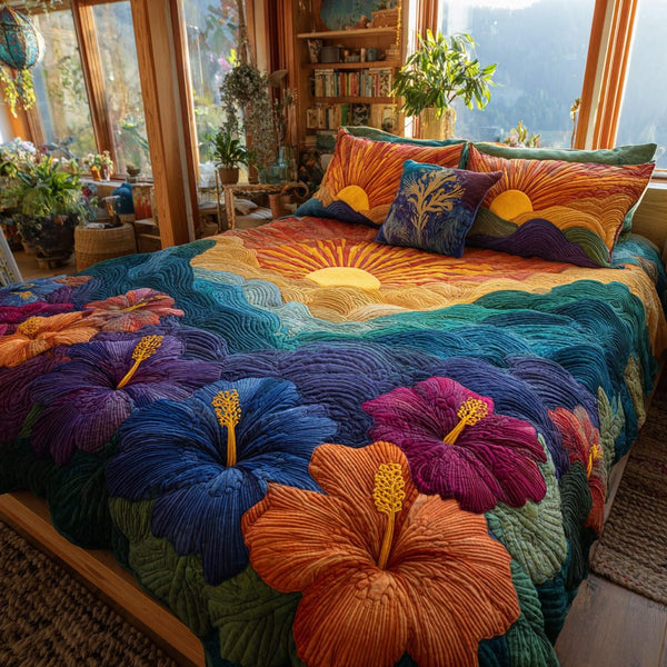 Sunset Blooms quilted 3-piece bedding set on a made bed with two matching pillow shams