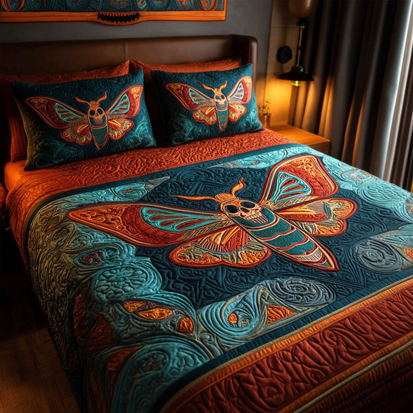 Sunset Emberwing quilted 3-piece bedding set on a made bed with two matching pillow shams