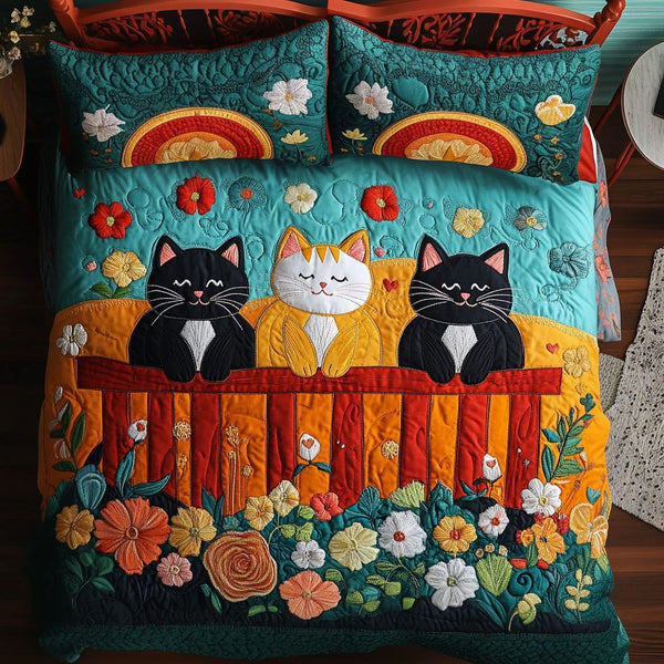 Sunset Fence Cats quilted 3-piece bedding set on a made bed with two matching pillow shams
