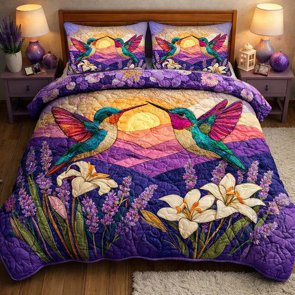 Sunset Harmony Hummingbirds quilted 3-piece bedding set on a made bed with two matching pillow shams