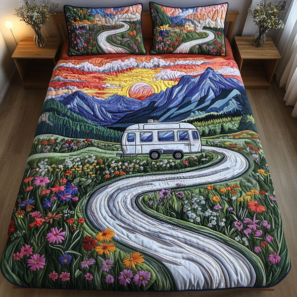 Sunset Journey quilted 3-piece bedding set on a made bed with two matching pillow shams