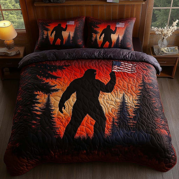 Sunset Sasquatch quilted 3-piece bedding set on a made bed with two matching pillow shams