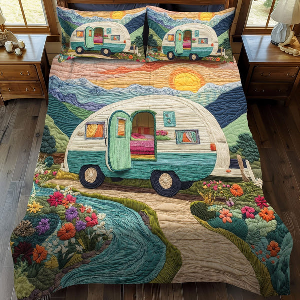 Sunset Voyage quilted 3-piece bedding set on a made bed with two matching pillow shams