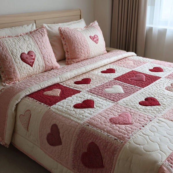 Sweet Heart quilted 3-piece bedding set on a made bed with two matching pillow shams