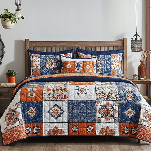 Tangerine Symphony quilted 3-piece bedding set on a made bed with two matching pillow shams