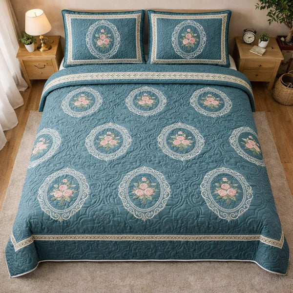Teal Floral Medallion quilted 3-piece bedding set on a made bed with two matching pillow shams
